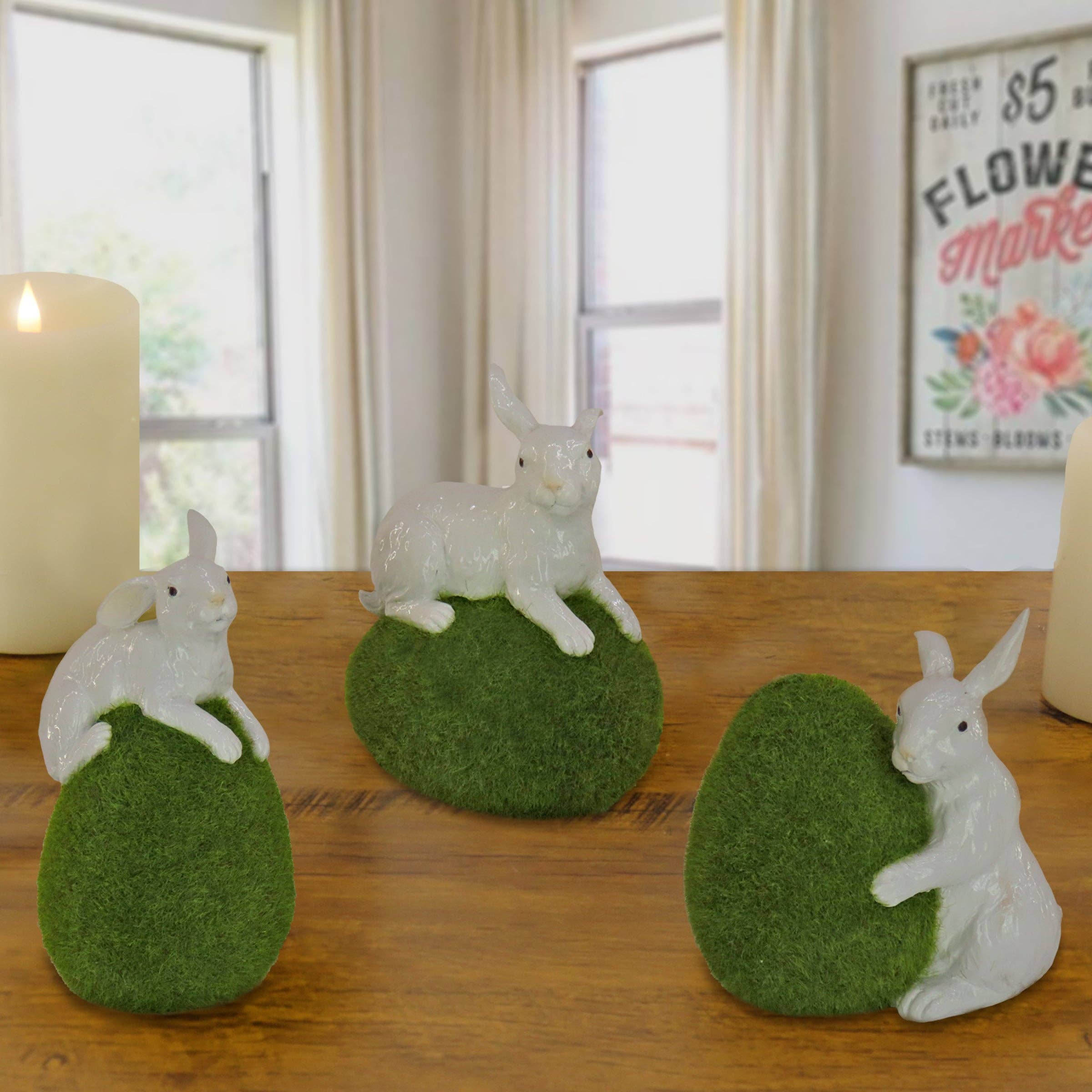 7 in. White Easter Rabbit Figures on Green Moss Covered Eggs, Set of 3